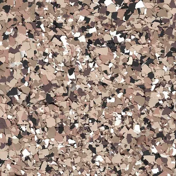 Abstract image featuring a blend of beige, brown, and black flakes scattered randomly, creating a textured pattern without any discernible objects or figures.